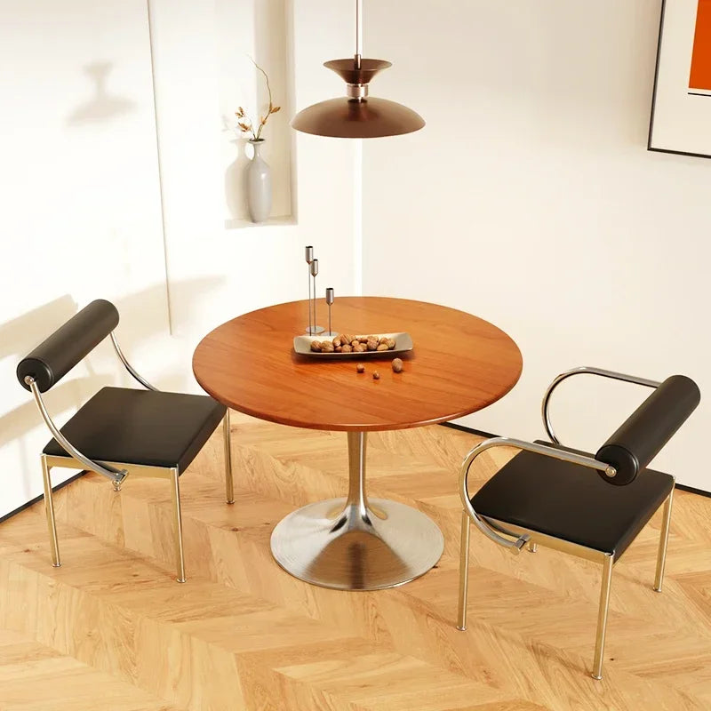 Fontaine Collection | Arched Steel-Framed Brushed Steel Dining Chair - presented at scale within a designed interior in a Mid-Century Modern dining room setting.