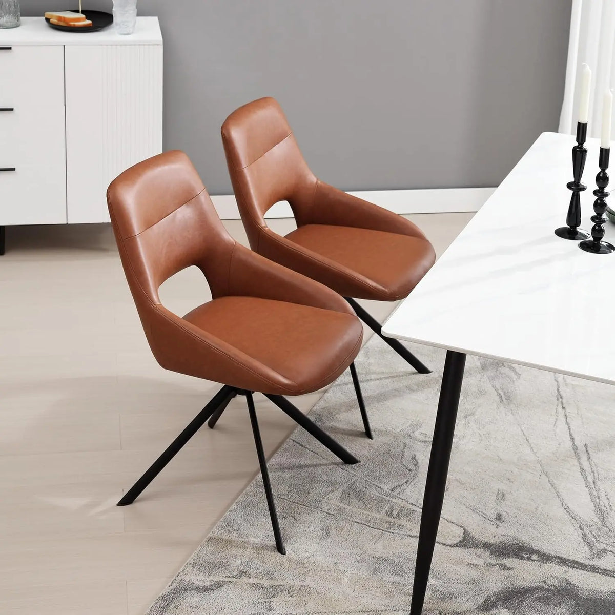 Ellington Collection | Sculptural Leather-Wrapped Swivel in Cognac Faux Leather - captured in a curated lifestyle vignette in a Mid-Century Modern living room setting.