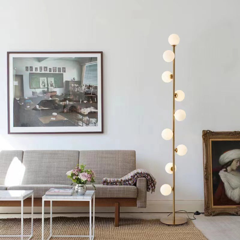 Astoria Collection | Geometric Brass-Accented Walnut & Brass Floor Lamp - captured in a curated lifestyle vignette in a Mid-Century Modern living room setting.