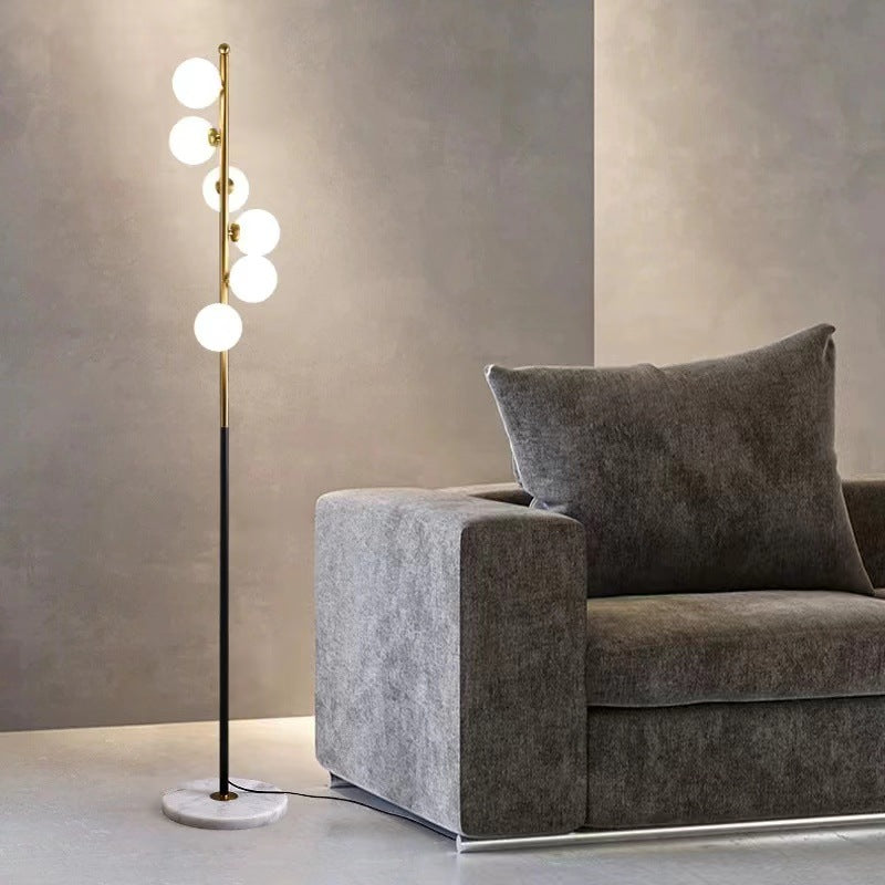 Astoria Collection | Geometric Brass-Accented Walnut & Brass Floor Lamp - styled from an alternate angle revealing dimensional depth in a Mid-Century Modern living room setting.