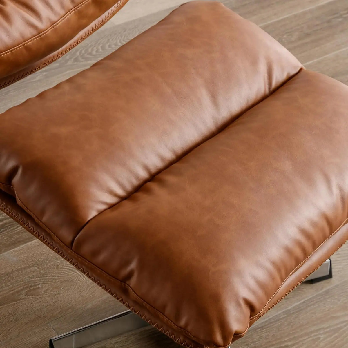 Ellington Collection | Floating Leather-Wrapped Walnut Swivel Chair and Ottoman - styled from an alternate angle revealing dimensional depth in a Mid-Century Modern living room setting.