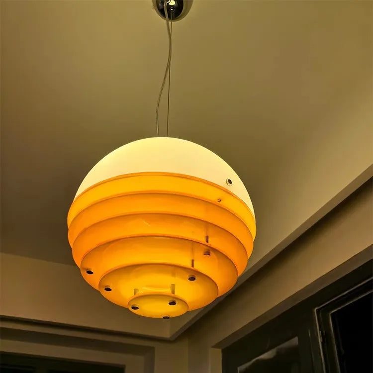 Fontaine Collection | Organic-Form Glass-Topped Sunset Glass Pendant - showcasing full sculptural form and curated finish in a Mid-Century Modern living room setting.
