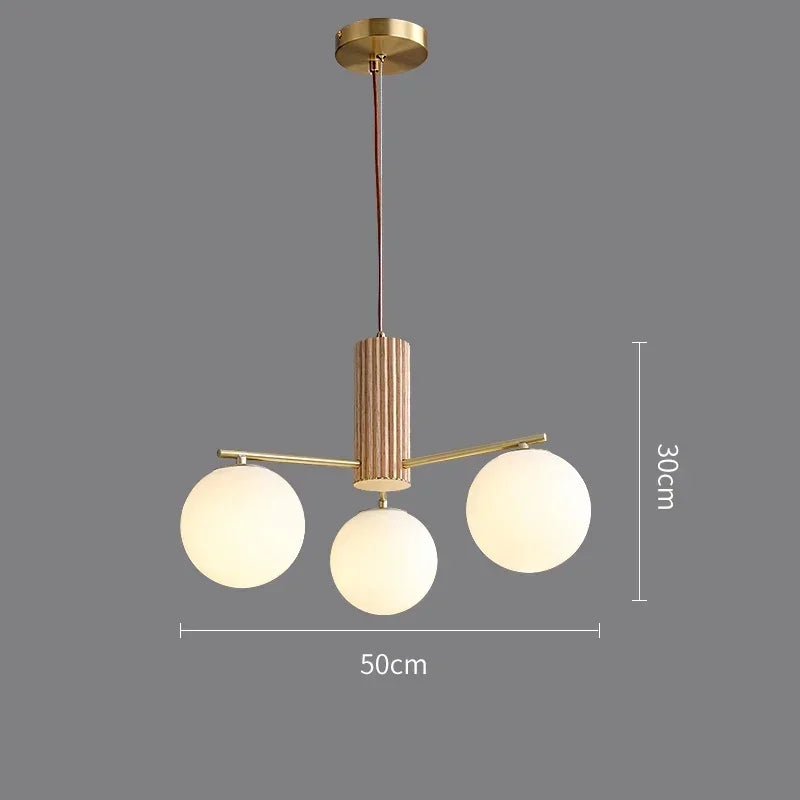 Fontaine Collection | Sculptural Glass-Topped Rose Glass Sphere Chandelier - captured in a curated lifestyle vignette in a Mid-Century Modern living room setting.