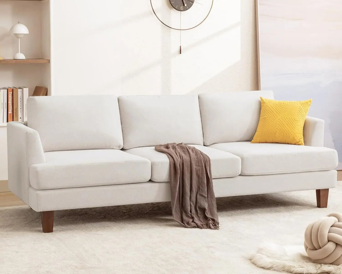 Astoria Collection | Tapered-Leg Leather-Wrapped Walnut Sofa - framed in an editorial still-life composition in a Mid-Century Modern living room setting.