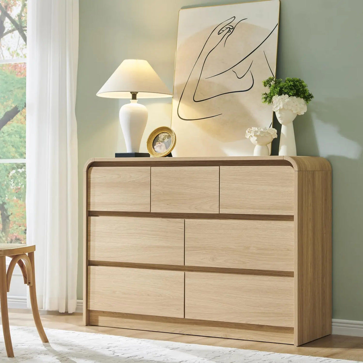 Valencia Collection | Sculptural Curved Curved Walnut Dresser - exhibiting shadow play and geometric silhouette detail in a Mid-Century Modern bedroom setting.