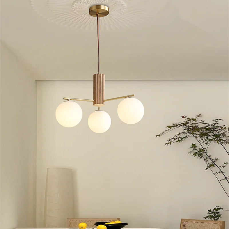 Fontaine Collection | Sculptural Glass-Topped Rose Glass Sphere Chandelier - showcasing full sculptural form and curated finish in a Mid-Century Modern living room setting.