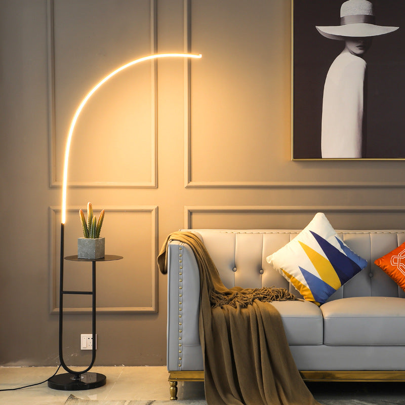 Ellington Collection | Sculptural Glass-Topped Walnut & Brass LED Bedside Lamp - revealing tonal warmth and surface patina under ambient light in a Mid-Century Modern bedroom setting.