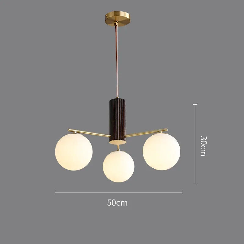 Fontaine Collection | Geometric Stone-Top Rose Quartz Chandelier - demonstrating proportional harmony within the collection in a Mid-Century Modern living room setting.