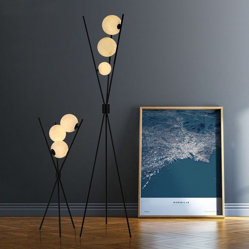 Ellington Collection | Geometric Atomic-Era Tri-Orb LED Floor Lamp - presented at scale within a designed interior in a Mid-Century Modern living room setting.