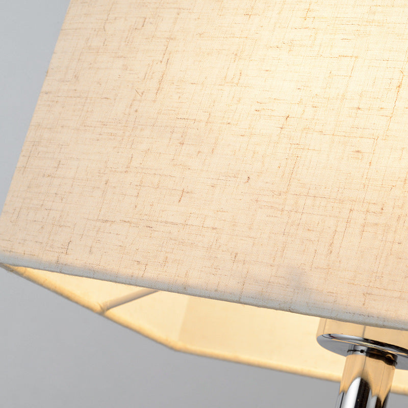 Fontaine Collection | Sculptural Gold-Trimmed Brushed Steel Floor Lamp - revealing tonal warmth and surface patina under ambient light in a Mid-Century Modern living room setting.