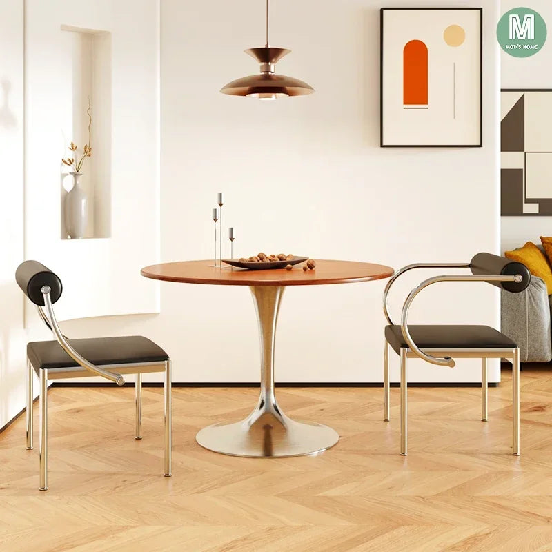 Fontaine Collection | Arched Steel-Framed Brushed Steel Dining Chair - framed in an editorial still-life composition in a Mid-Century Modern dining room setting.