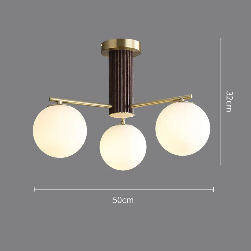 Fontaine Collection | Geometric Stone-Top Rose Quartz Chandelier - captured in a curated lifestyle vignette in a Mid-Century Modern living room setting.