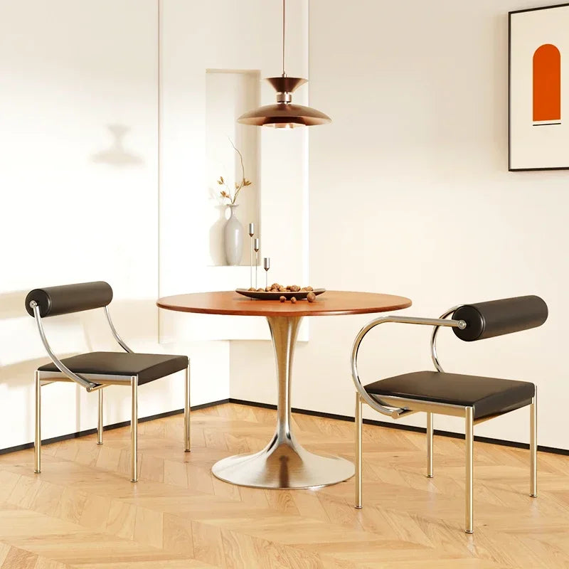 Fontaine Collection | Arched Steel-Framed Brushed Steel Dining Chair - revealing tonal warmth and surface patina under ambient light in a Mid-Century Modern dining room setting.