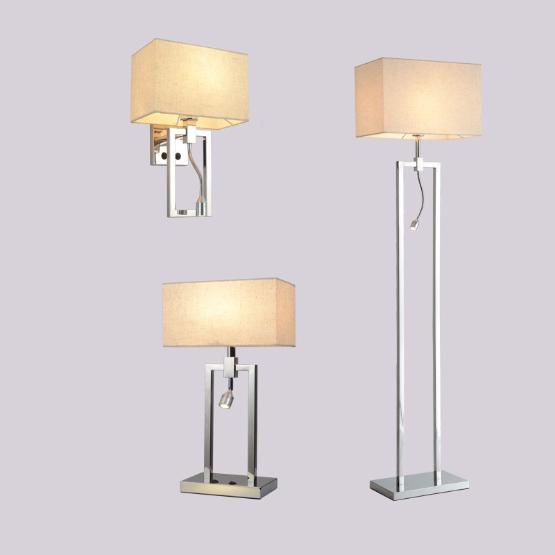Fontaine Collection | Sculptural Gold-Trimmed Brushed Steel Floor Lamp - presented at scale within a designed interior in a Mid-Century Modern living room setting.