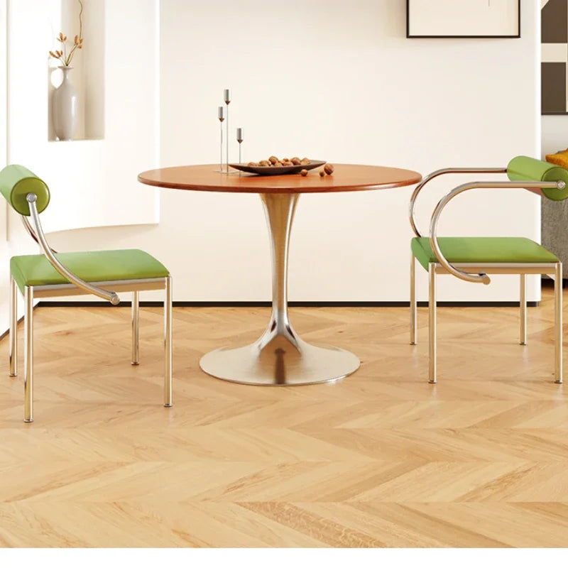 Fontaine Collection | Arched Steel-Framed Brushed Steel Dining Chair - demonstrating proportional harmony within the collection in a Mid-Century Modern dining room setting.