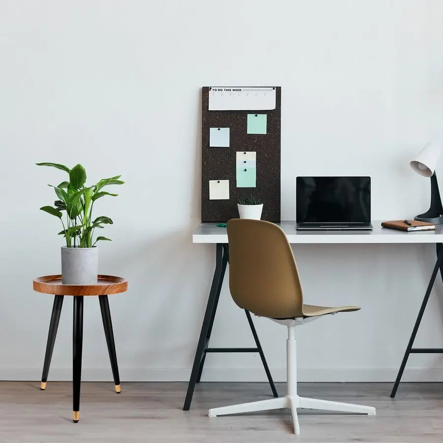 Fontaine Collection | Tapered-Leg Round Walnut Plant Stand - styled from an alternate angle revealing dimensional depth in a Mid-Century Modern living room setting.